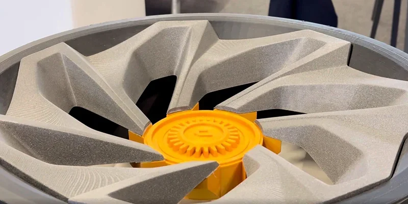 Modix Everest 3D-printed geometric sculpture in gray and orange, showcasing intricate design and precision engineering.