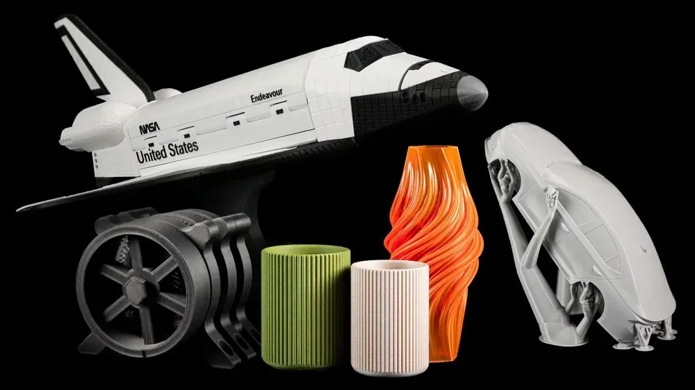 3D printed models including a space shuttle, engine, and vase showcase the capabilities of the Original Prusa MK4S 3D Printer Kit.