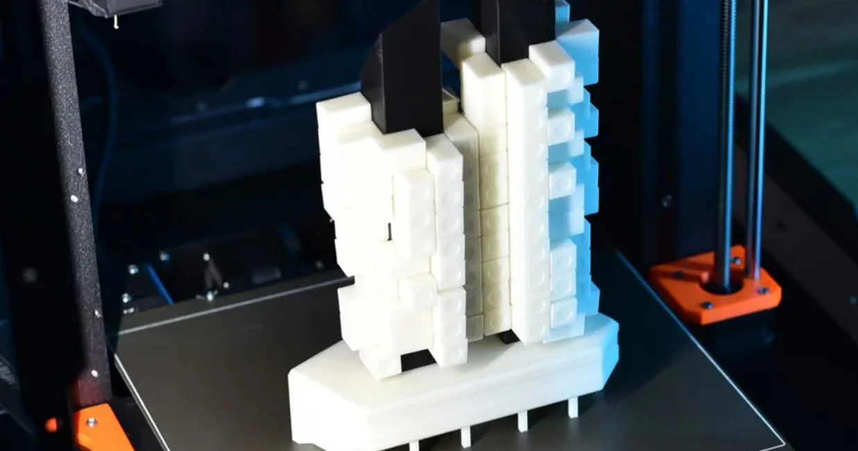 Original Prusa MK4S 3D Printer Kit creating a complex white and black 3D structure on a flat build plate.