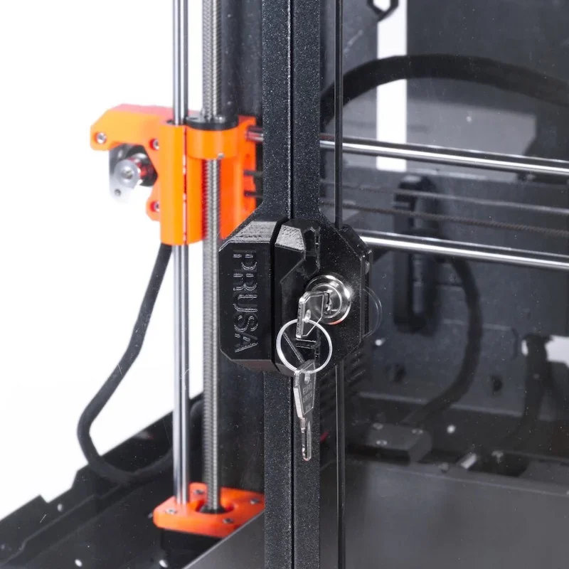 Original Prusa MK4S 3D printer kit showing a close-up of the lockable enclosure with a key. Orange and black components are visible.