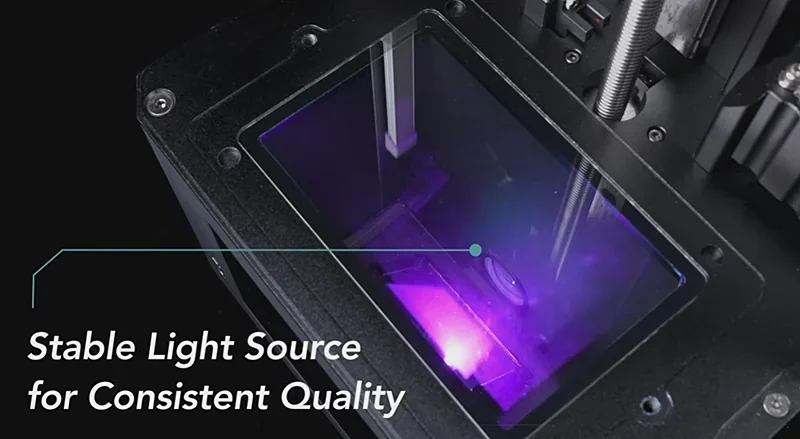 Phrozen Lumii DLP 3D printer with stable light source for consistent quality, showing purple illumination in print area.