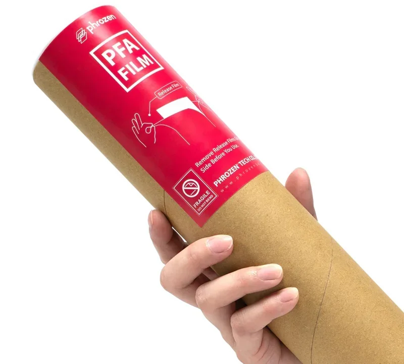Phrozen Lumii DLP PFA film roll held in hand, red label with branding, designed for 3D printing applications, highlighting durability and usage.