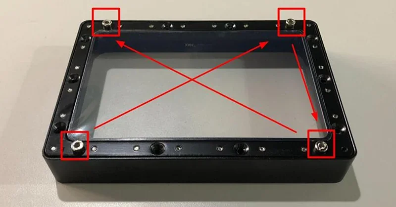 Clear resin vat for Phrozen Lumii DLP 3D printer with red arrows marking key points, screws, and design features on a light-colored surface.