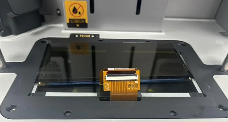 Phrozen Sonic CS+ 3D printer showcasing the build plate and control interface inside, highlighting intricate components and technology design.