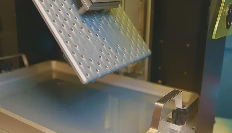 Phrozen Sonic Mega 8K 3D printer build plate over resin vat, showcasing precision design for creating detailed samples or parts.