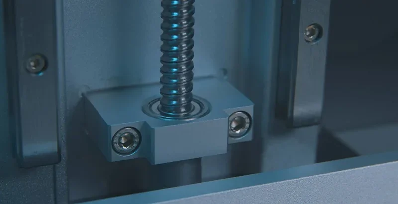 Phrozen Sonic Mega 8K screw mechanism, metallic parts, detailed engineering. Close-up of printer components, showcasing precision and design quality.