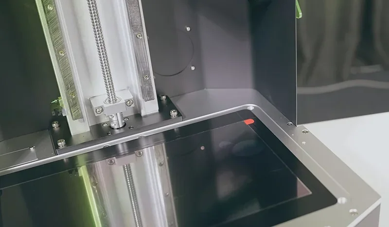 Phrozen Sonic Mega 8K 3D printer interior, showcasing resin vat and build plate, emphasizes advanced precision, with metal components and sleek design.