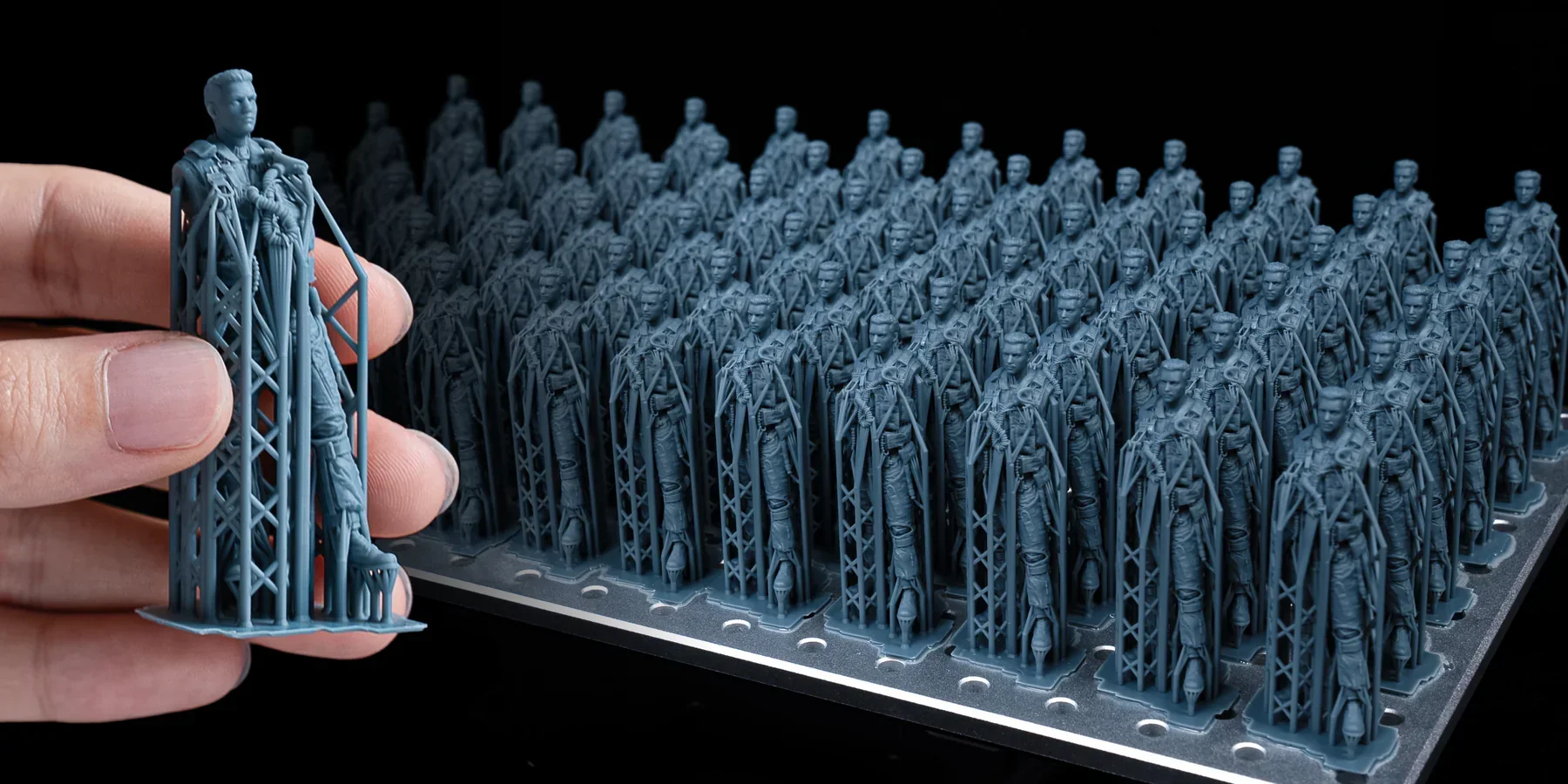 Phrozen Sonic Mega 8K prints detailed blue miniatures on a platform, showcasing precision and high-quality 3D printing capability.