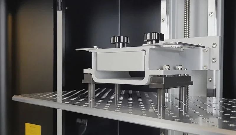 Phrozen Sonic Mega 8K V2 printer interior showcasing build plate and metallic components, highlighting precision engineering and advanced 3D printing capabilities.