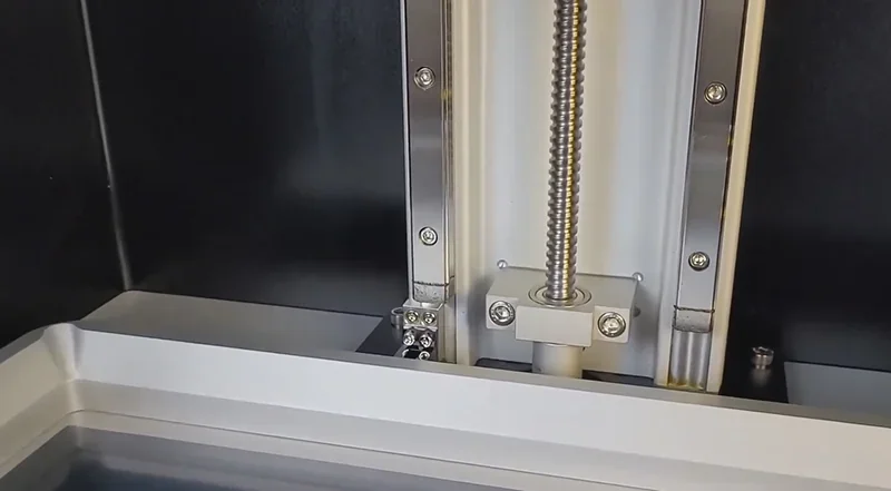 Phrozen Sonic Mega 8K V2's internal metal mechanisms and build plate detail, showcasing precision engineering and sturdy construction.