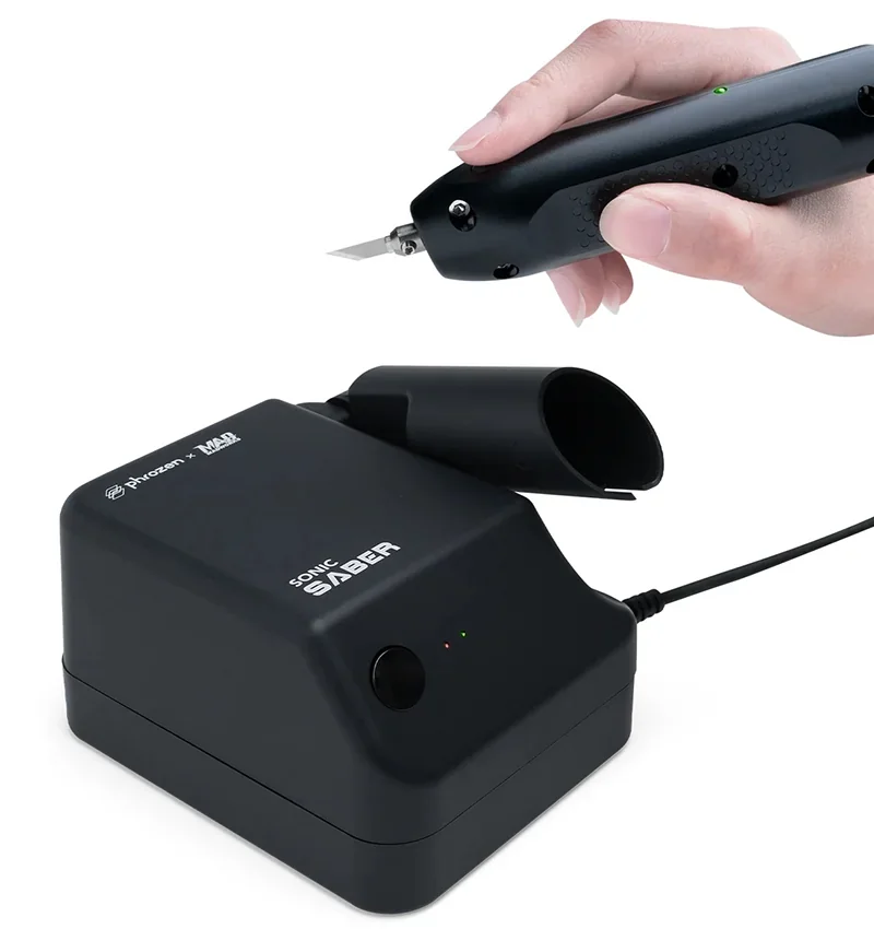 Hand holds black sonic saber tool connected to Phrozen unit with logo.