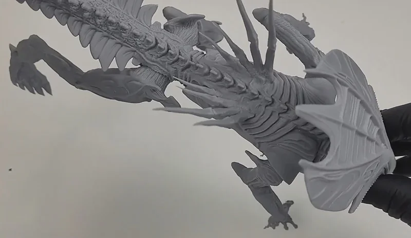 Phrozen Sonic Mega 8K V2 dragon model detailing, showcasing intricate scales and features, crafted with precision, held by a hand in black gloves.