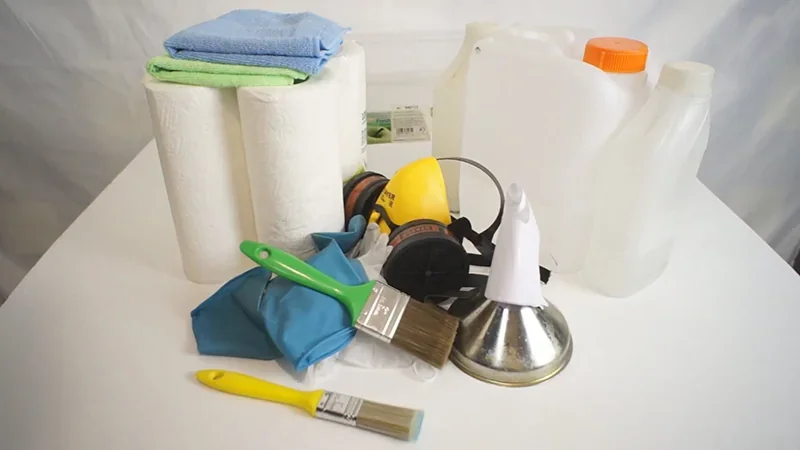 Cleaning tools and safety gear, including brushes, respirator, gloves, and paper towels, for maintaining the Phrozen Sonic Mega 8K V2 3D printer.