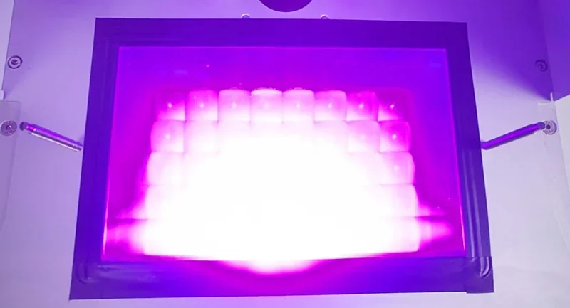 Phrozen Sonic XL 4K Plus printer with vibrant purple UV light over the print bed, showcasing 3D printing precision.
