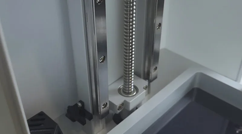 Phrozen Sonic XL 4K Plus 3D printer interior showing metal z-axis components and build plate area, highlighting precision engineering.