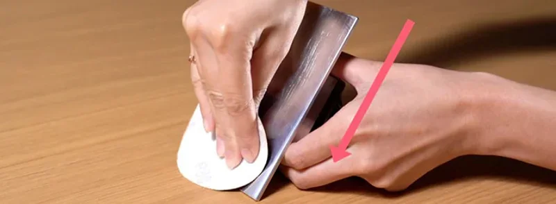 Hands polishing a 3D-printed part with sandpaper, showcasing the smooth surface finish achievable by the Phrozen Sonic XL 4K Plus printer.