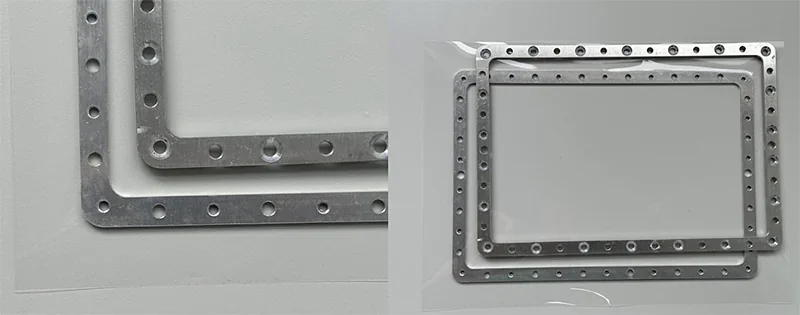 Metal frames with multiple holes, likely crafted by Phrozen Sonic XL 4K Plus 3D printer, displayed against a plain background.