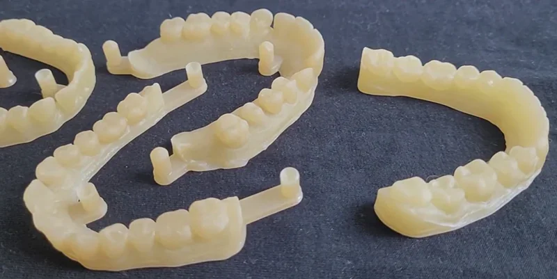 Dental molds printed by Phrozen Sonic XL 4K Plus, displayed on a dark surface.