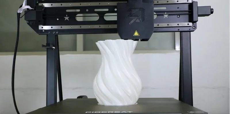 Piocreat G5 3D printer fabricating a detailed, twisting white vase design on its print bed, showcasing precision and advanced technology.
