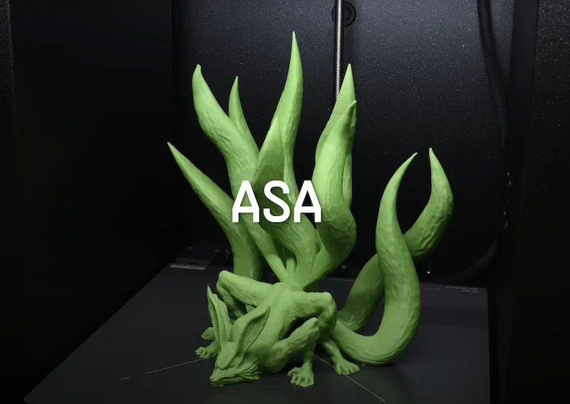 Green 3D printed creature with multiple tentacles made by Prusa Core One, labeled "ASA," inside a black 3D printer.