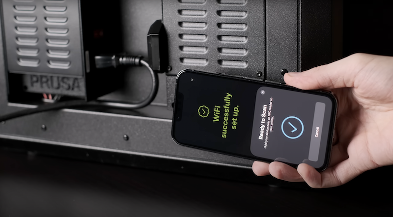 A hand holding a smartphone displays a message reading "WiFi successfully set up" with a green checkmark. Below, it says "Ready to Scan" with instructions for pressing the loader h