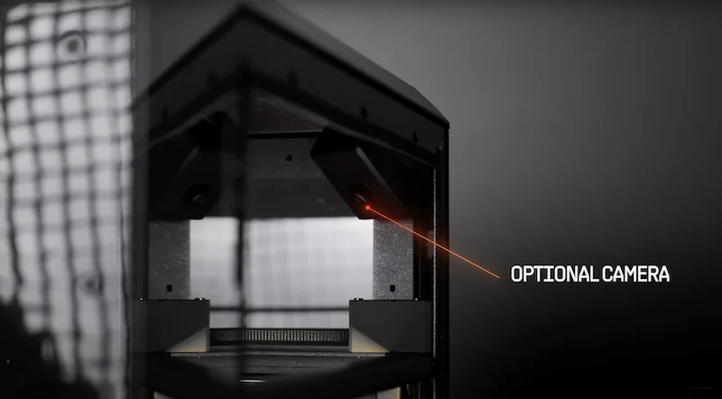 Prusa Core One 3D printer with a sleek, angled frame, showcasing an optional camera feature inside, highlighted by a red laser line.