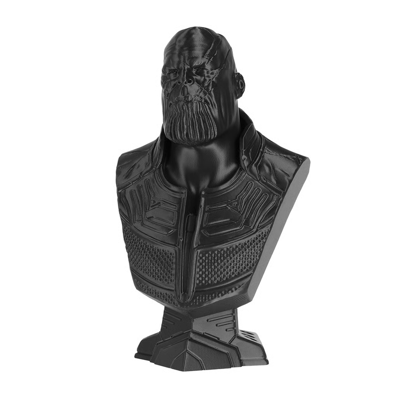 A detailed orange 3D-printed model featuring a spiraling tower with a staircase and a dramatic wave created by the Prusa Core One. The tower is intricately designed, surrounded by a wave formation and a fragmented structure resembling a shipwreck. The high level of detail showcases the printer's capability in producing complex, fine structures.