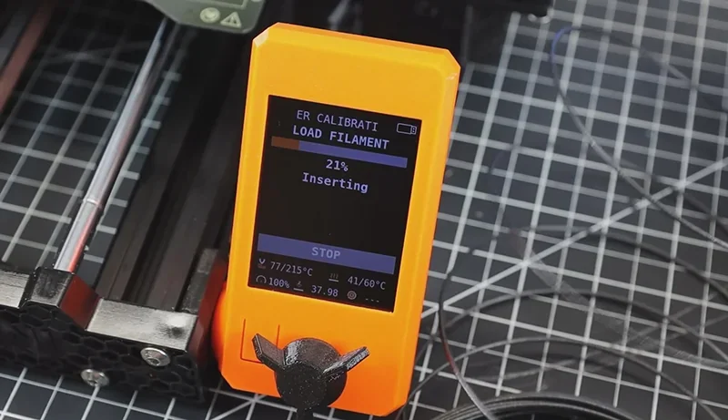 Prusa Mini 3D printer control screen displaying filament loading status on a grid surface.