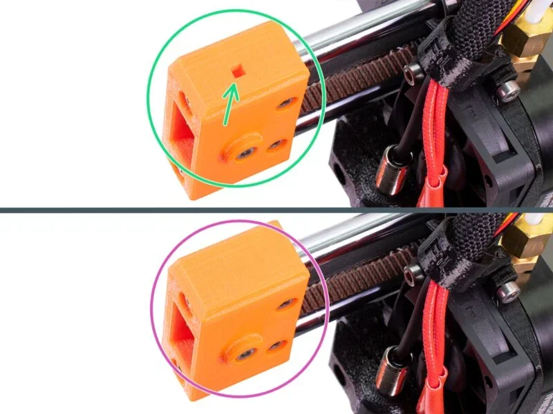 Prusa Mini 3D printer part comparison showing two orange components with different screw placements and design details, highlighting print precision.