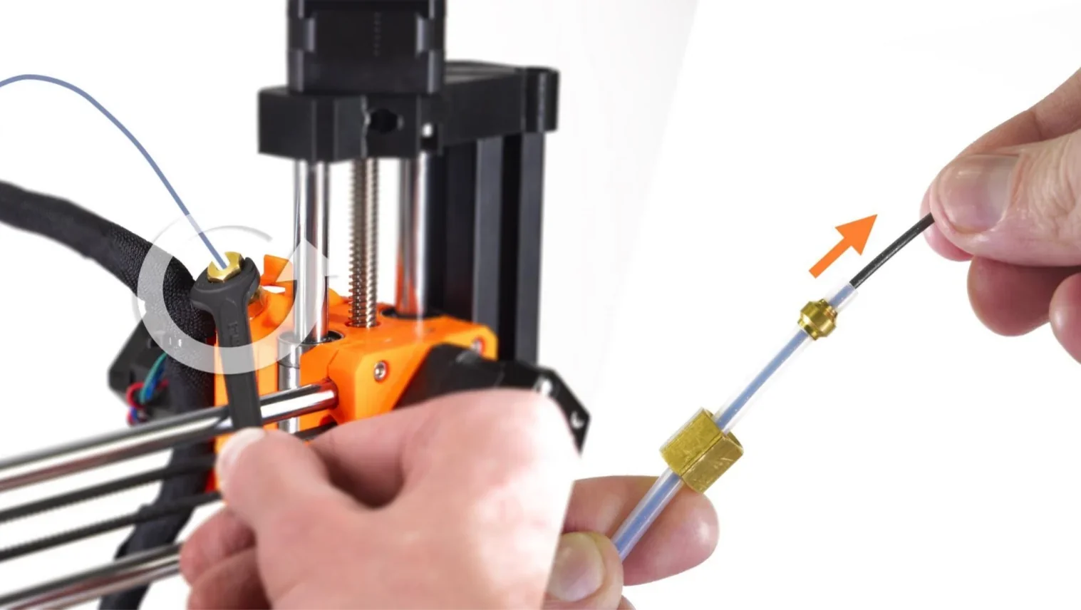 Prusa Mini 3D printer filament feed assembly, showing hands connecting a filament guide tube with fitting, on a white background.