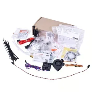 Prusa Mini kit components spread out, including cables, fan, zip ties, and manuals, ready for assembly or repair.