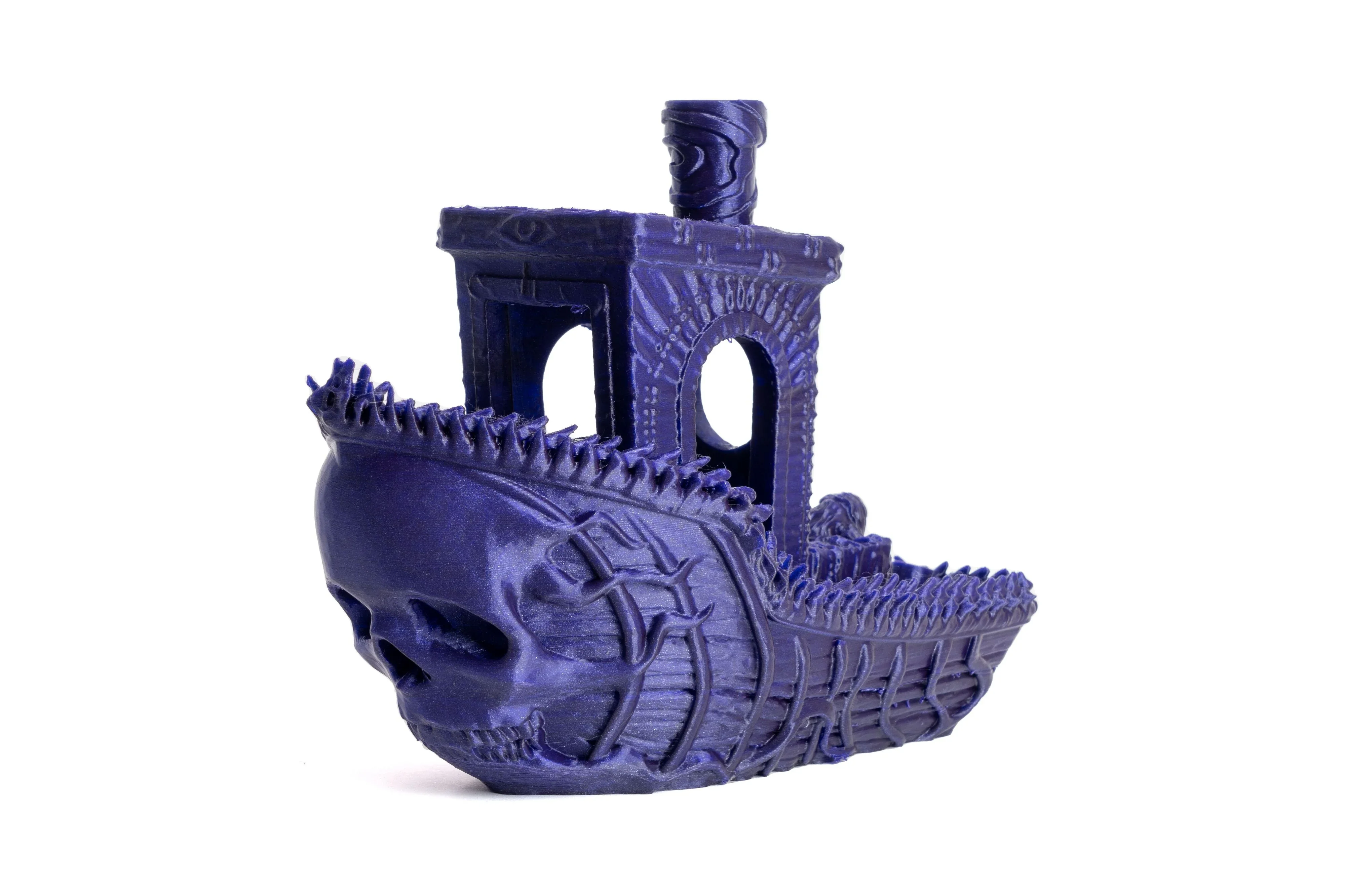 Detailed purple 3D-printed boat with skull design created by Prusa MK4, showcasing intricate patterns and textures.