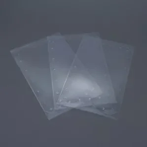 Clear resin sheets possibly for use with the Prusa SL1S 3D printer, displayed overlapping on a dark surface, showing transparency and texture.