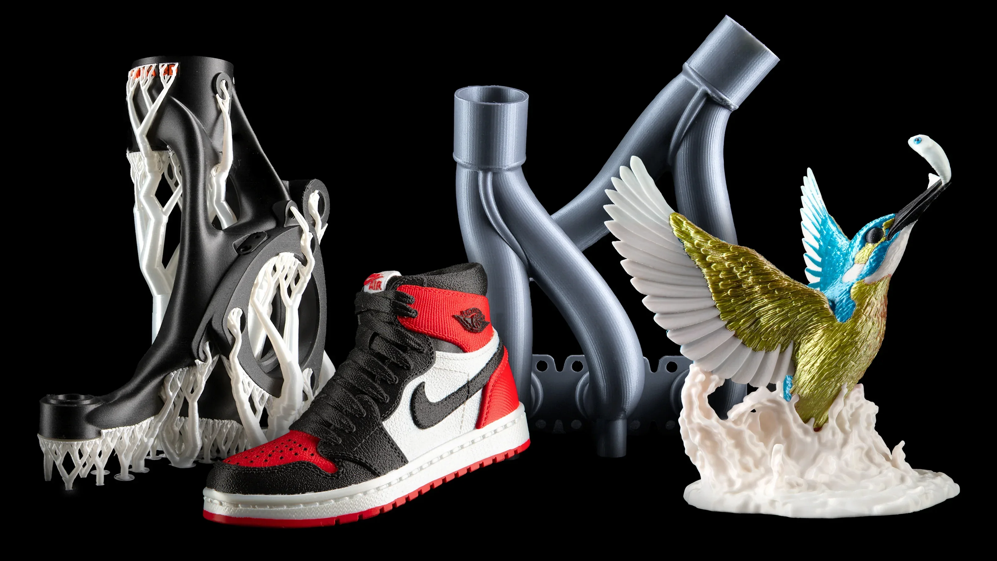 3D prints by Prusa XL: complex black model, sneaker, gray tubes, colorful bird sculpture on black background.