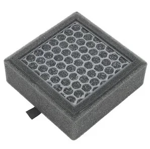 A black foam pad with hexagonal holes, likely a sample part designed by Prusa XL, showcasing intricate 3D printing capabilities.