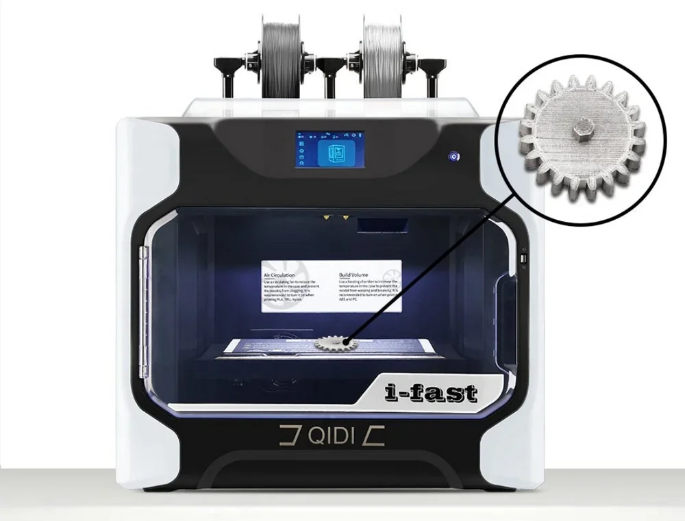 Qidi i-fast 3D printer with a gear part displayed, highlighting its printing capability. Dual spools positioned on top show filament setup.