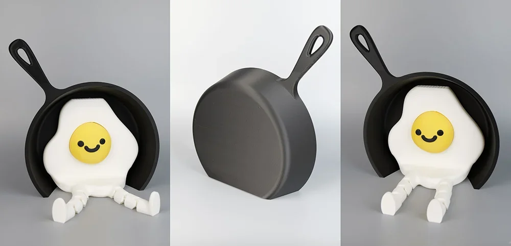 Qidi X Max 3D printed frying pan with a smiling egg character featuring legs, seen from various angles on a neutral backdrop.