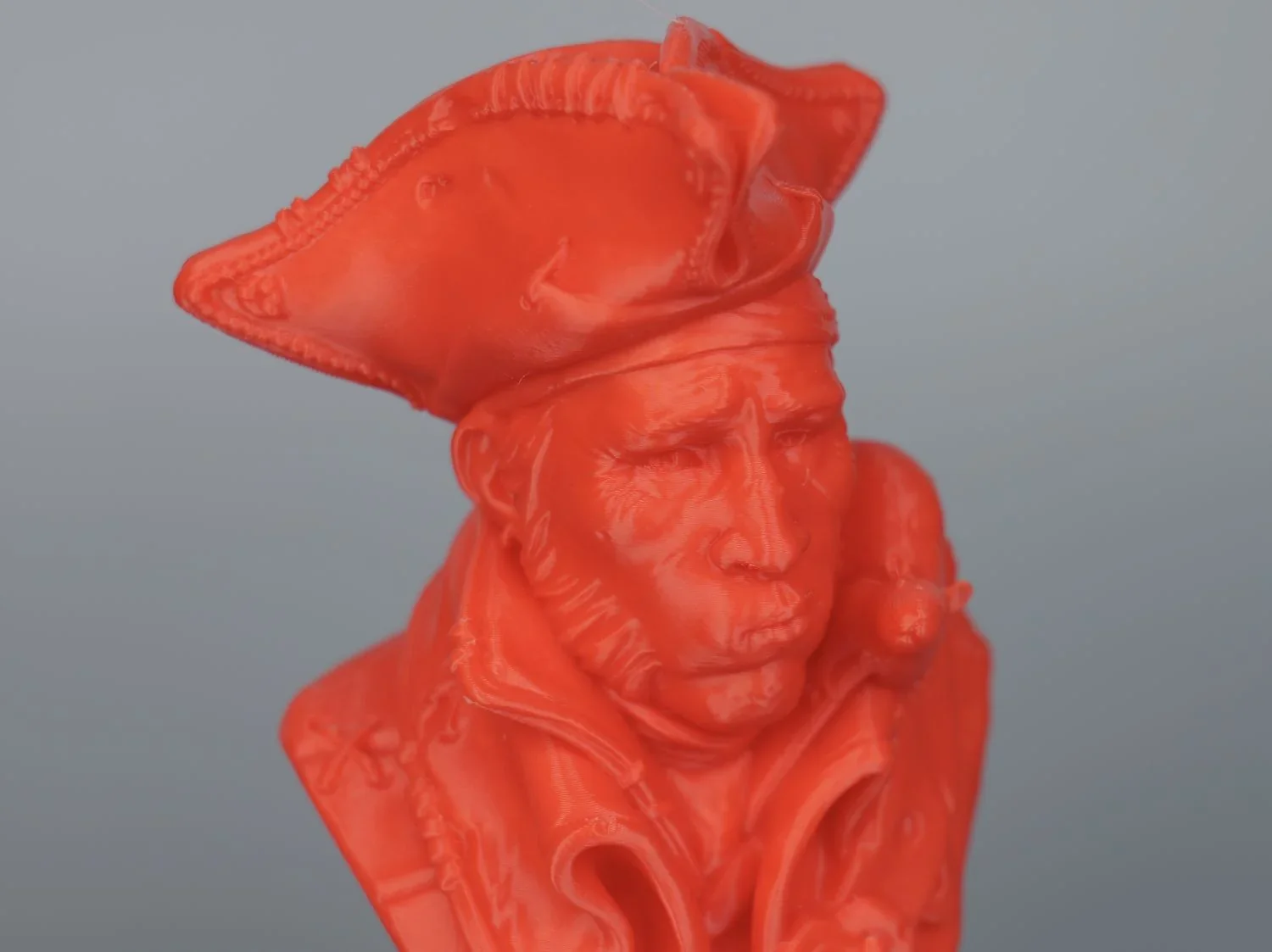Intricate red pirate bust 3D printed by Qidi X Max, showcasing detailed facial features and attire with a tricorn hat.