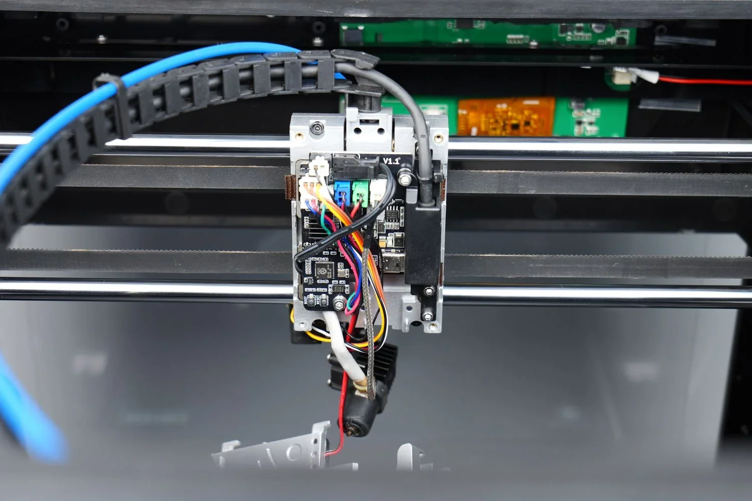 Qidi X Max 3D printer with exposed wiring and components, showing intricate internal details, showcasing the machine's build and technology.