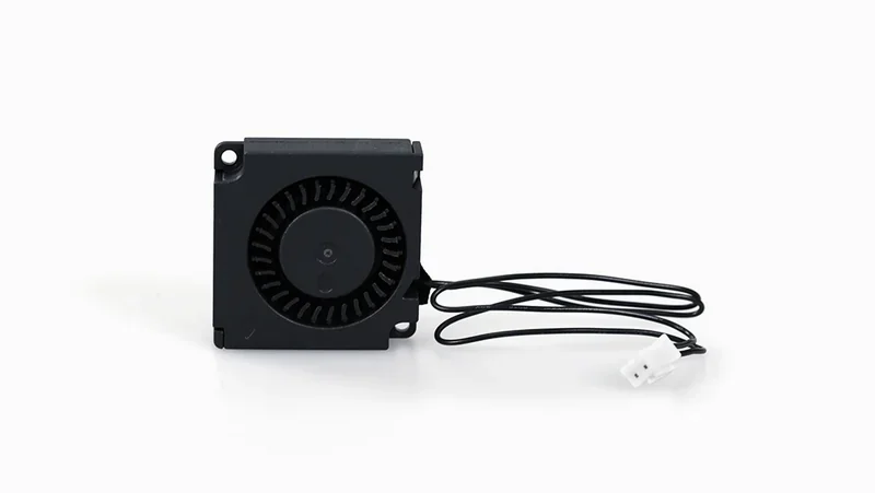 Black plastic fan component with wires, used in Raise3D E2 3D printer for cooling.