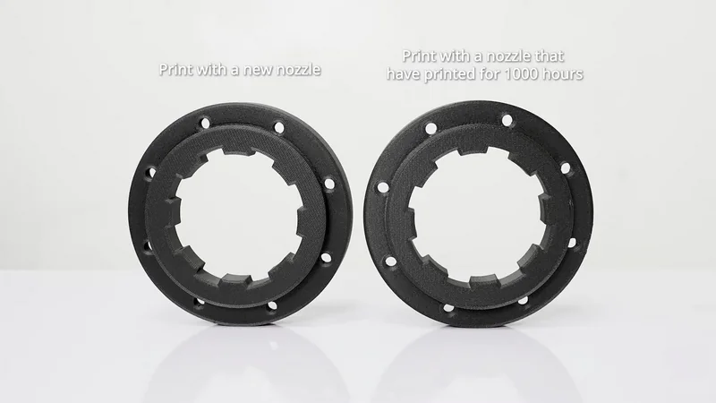 Raise3D E2CF printed parts comparison: left shows new nozzle print, right shows 1000-hour used nozzle print. Black rings with boltholes on white background.