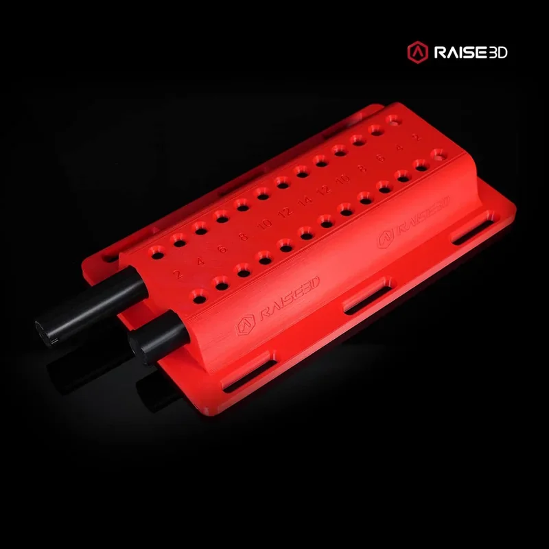 Red perforated block printed by Raise3D E2CF, featuring numbered holes and brand logo on a black background.