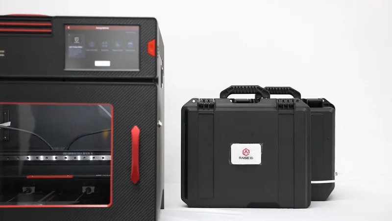Raise3D E2CF printer with touchscreen, carbon fiber body, and black cases, set against a white background.