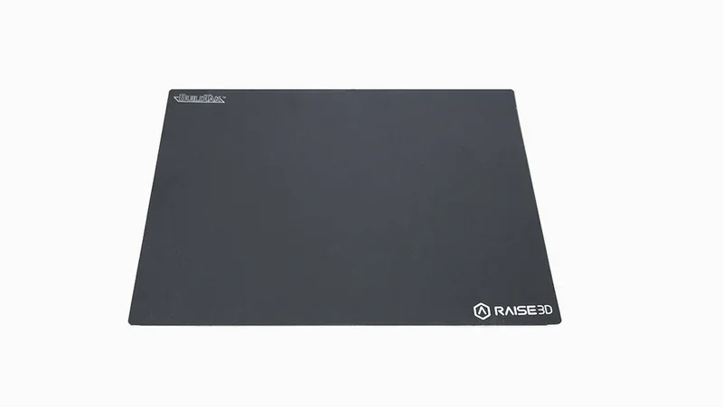 Raise3D E2CF printing surface with branding logo on a flat, black matte finish.