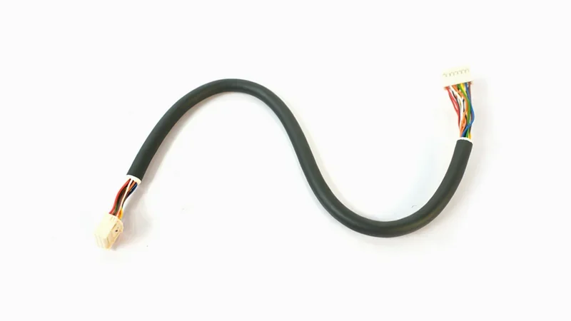 Black cable with multicolored wires and connectors is a sample created by Raise3D E2CF printer, displayed on a plain white background.