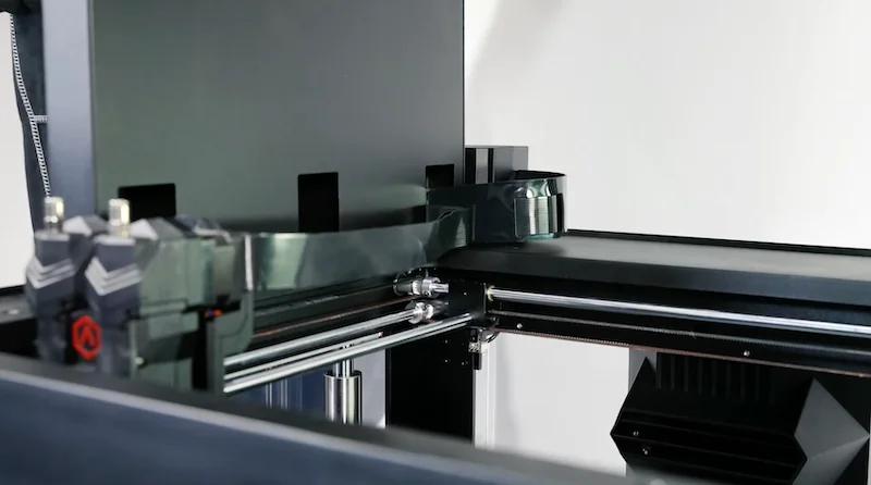 Raise3D Metalfuse 3D printer in action, featuring sleek metal components and mechanical parts, designed for creating precise, high-quality samples.