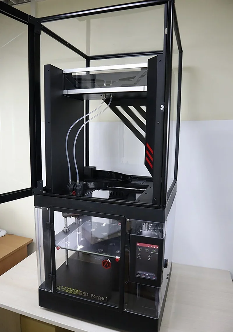 Raise3D Metalfuse 3D printer with a black frame, glass enclosure, and touchscreen showing interface, designed for metal part production.
