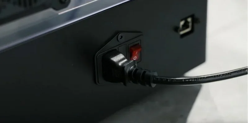 Power switch and cord port of Raise3D MetalFuse 3D printer, emphasizing back panel details and connectivity options for device setup.