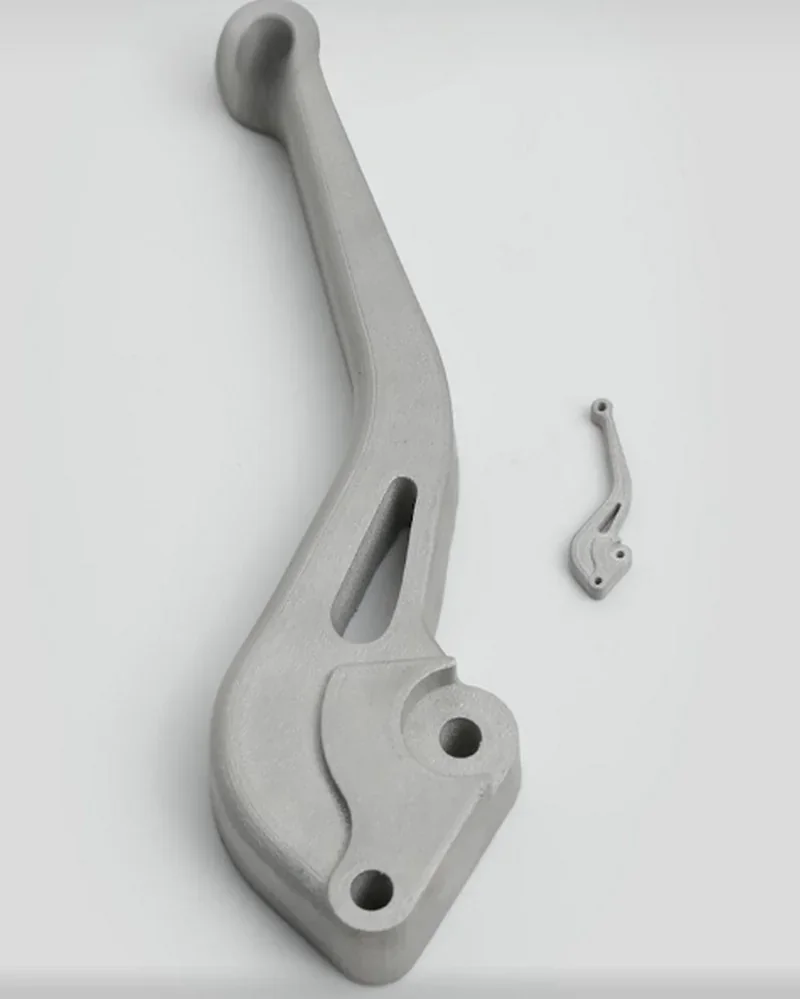 Raise3D MetalFuse 3D printed metal components shown, showcasing precision and smooth finish, presented on a plain background.