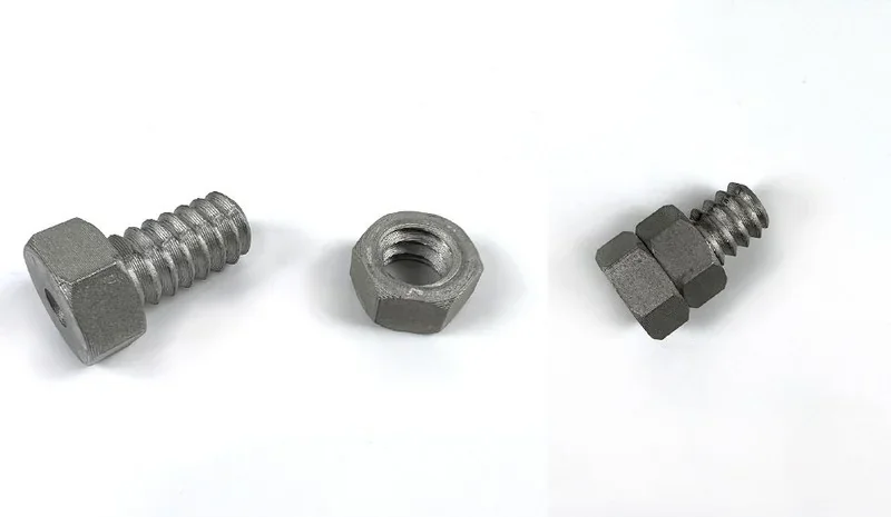 Metal bolts and nuts 3D-printed by Raise3D MetalFuse, displayed on a white background.